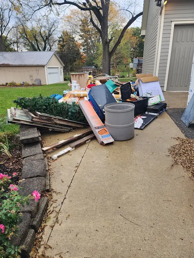 Dumpster being loaded with debris for Residential Dumpster Rental in Carrollton